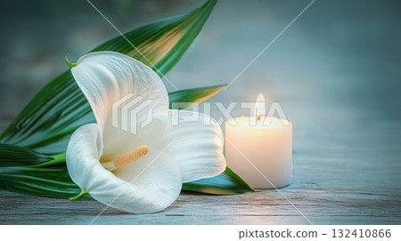 A white lilies calla flower with water droplets beside lit candle, evoking emotion and memory. Funeral symbol A white lilies calla flower with water droplets beside lit candle, evoking emotion and memory. Funeral symbol 132410866