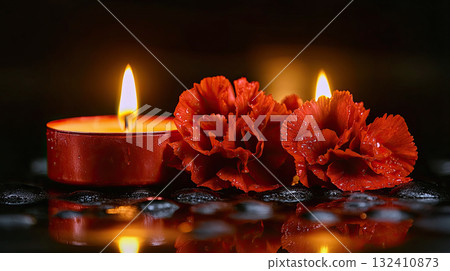 Beautiful red roses and candle on table against black background. Funeral symbol. Burning candle placed between two white roses dark surface, symbolizing remembrance. 132410873