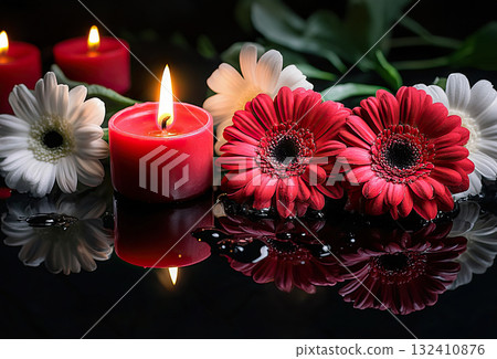 Beautiful red roses and candle on table against black background. Funeral symbol. Burning candle placed between two white roses dark surface, symbolizing remembrance. 132410876