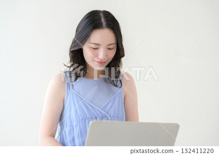 Woman operating a personal computer Woman operating a personal computer 132411220