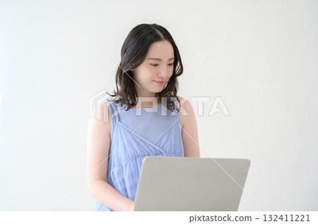 Woman operating a personal computer Woman operating a personal computer 132411221