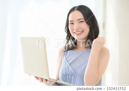 A woman holding a computer and doing a guts pose 132411552