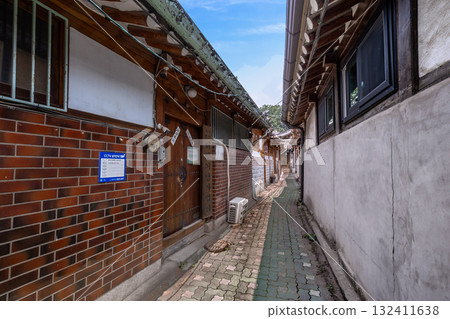 A narrow, traditional alleyway on Yulgok-ro 10-gil featuring brick and Hanok architecture 132411638
