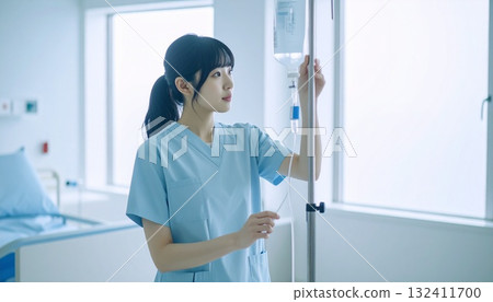 A young nurse checking an IV drip with a serious expression A young nurse checking an IV drip with a serious expression 132411700