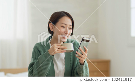 Woman operating a mobile phone 132411917