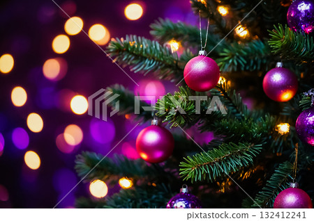 Green christmas tree with the balls ornament hanging on the branches on the colorful bokeh background. 132412241