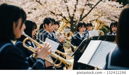 High school girls from the brass band playing under the cherry blossom trees High school girls from the brass band playing under the cherry blossom trees 132412298