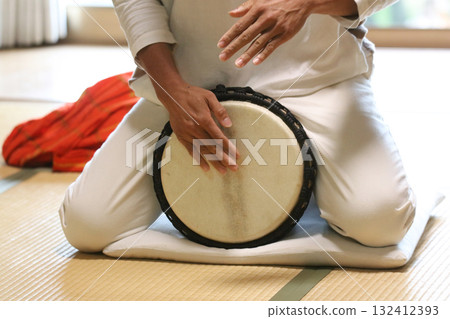 Man playing the djembe Man playing the djembe 132412393