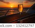 Celebration at sunset with a glass of sparkling drink on a boat in the ocean. 132412797