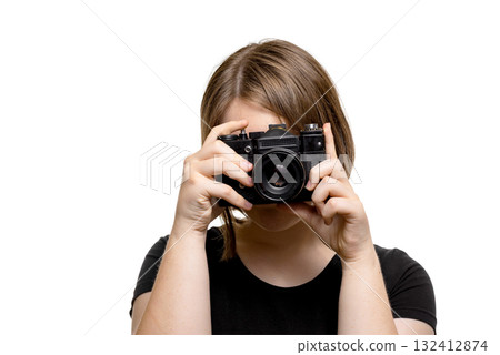 Young woman in black t-shirt taking a picture with camera, isolated on white background. Young woman in black t-shirt taking a picture with camera, isolated on white background. 132412874
