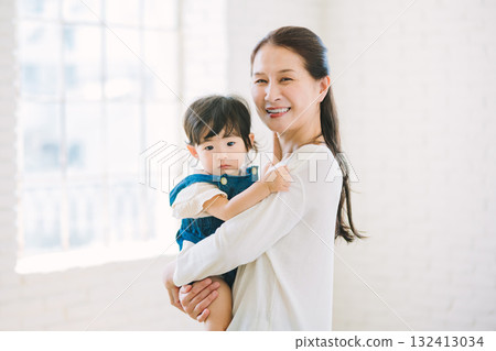 Grandma holding a baby Grandma holding a baby 132413034