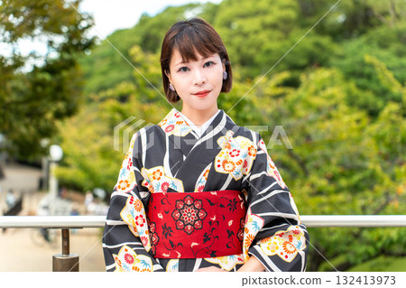 A stylish Japanese woman in a kimono A stylish Japanese woman in a kimono 132413973
