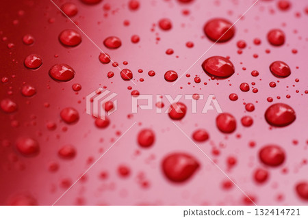 Closeup rain drops on red car with hydrophobic coating Closeup rain drops on red car with hydrophobic coating 132414721