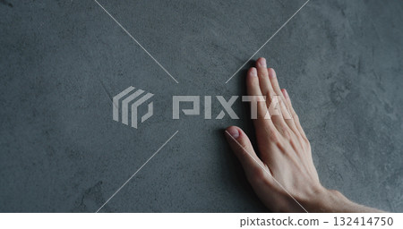 man hand touches decorative concrete finish 132414750