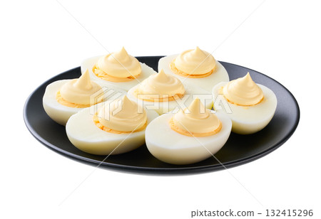 hard boiled chicken eggs with mayonnaise in a black plate isolated on a white background. 132415296