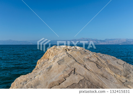 Large rocks in the artificial harbor bay near the village of Roda on the island of Corfu Large rocks in the artificial harbor bay near the village of Roda on the island of Corfu 132415831