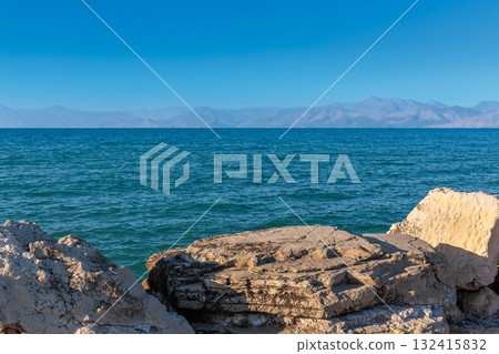 Large rocks in the artificial harbor bay near the village of Roda on the island of Corfu 132415832