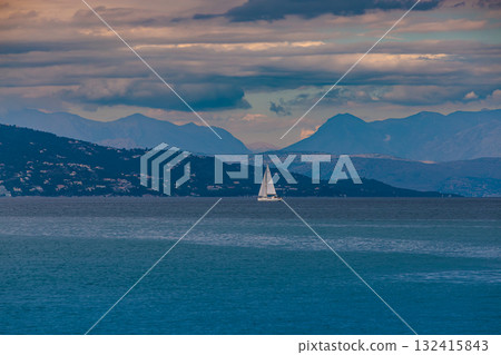 White sailboat on the Ionian Sea after sunset near the island of Corfu 132415843