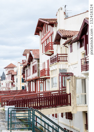 A street lined with historic red and white buildings in Saint-Jean-de-Luz, Basque Country, France 132416324