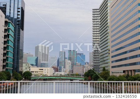 Skyscrapers by the river under a cloudy sky 132416550