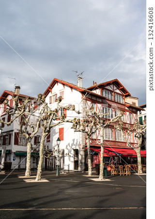A street lined with historic red and white buildings in Saint-Jean-de-Luz, Basque Country, France 132416608