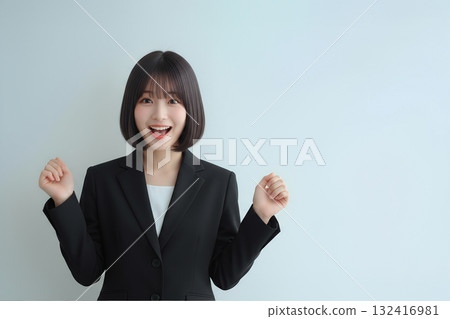 A smiling new female employee in a suit 132416981
