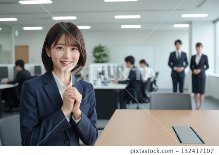 Smiling young businesswoman in the office 132417107