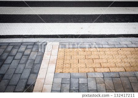 Close up of modern pedestrian crosswalk with white and black road stripes  132417211