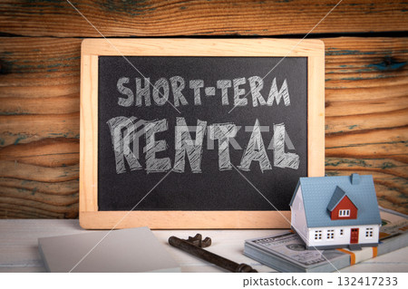 Short-Term Rental Concept. House model, key and money. Symbolizing property leasing, housing, and Short-Term Rental Concept. House model, key and money. Symbolizing property leasing, housing, and 132417233