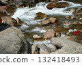 Cascading Mountain Stream Rushing Over Colorful Rocks 132418493