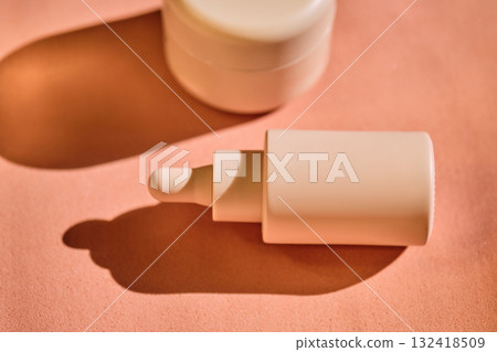 Bottles of facial serum in the beautiful sunset light. Bottles of facial serum in the beautiful sunset light. 132418509