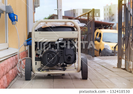 Business use mobile generator. Power supply generator placed on street sidewalk. Outdoor diesel power generator. Energy independence. Business use mobile generator. Power supply generator placed on street sidewalk. Outdoor diesel power generator. Energy independence. 132418530
