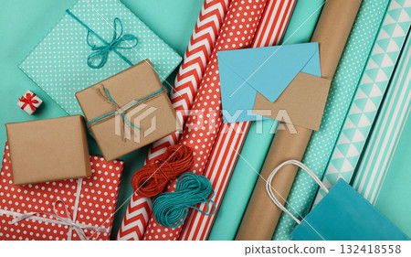 Packing gifts with red blue and brown paper Packing gifts with red blue and brown paper 132418558