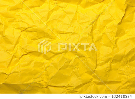Yellow crumpled paper creating an abstract texture background 132418584