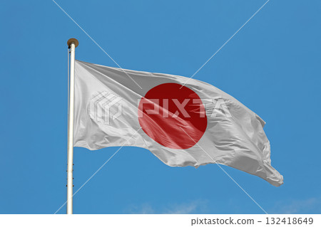 Japanese flag waving in cloudy blue sky Japanese flag waving in cloudy blue sky 132418649