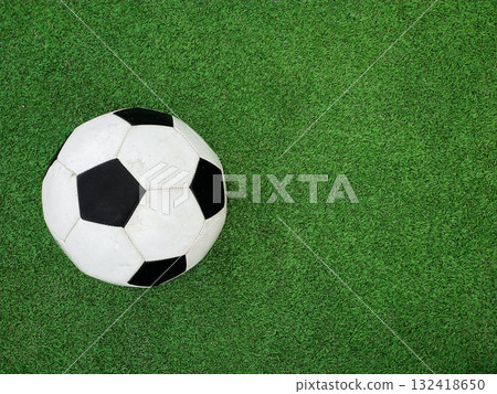 Football ball over green soccer field 132418650
