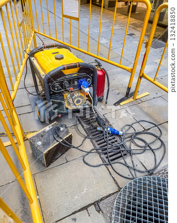 Portable Generator with Yellow Frame at Construction Site 132418850
