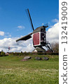 Millstones in a field in front of the Oostenwind windmill 132419009