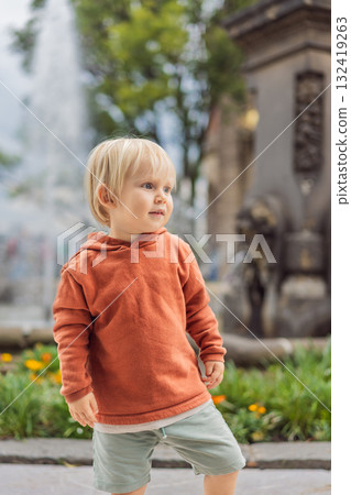 Little toddler tourist near Chapultepec Castle in Mexico City, exploring the landmark during family travel. Cultural heritage and tourism concept Little toddler tourist near Chapultepec Castle in Mexico City, exploring the landmark during family travel. Cultural heritage and tourism concept 132419263