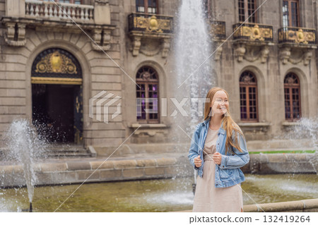 Young woman tourist standing near Chapultepec Castle in Mexico City, exploring the historic landmark. Solo travel, cultural heritage, tourism, and adventure concept Young woman tourist standing near Chapultepec Castle in Mexico City, exploring the historic landmark. Solo travel, cultural heritage, tourism, and adventure concept 132419264