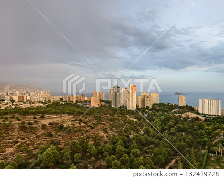 calm coastal city after storm, quiet coastal cityscape recovering under soft sunlight and clear 132419728