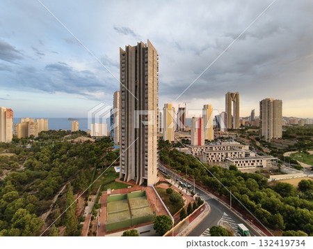 stormy coastal sunset, dusk over coast with tower, coastal skyline at dusk with looming clouds stormy coastal sunset, dusk over coast with tower, coastal skyline at dusk with looming clouds 132419734