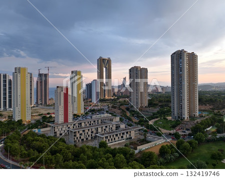 vivid cityscape lighting, vibrant skyscrapers glow at sunset with bustling streets and communal vibe 132419746