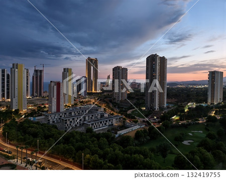 night cityscape view, calm night with illuminated skyline, silent city lights under evening sky 132419755