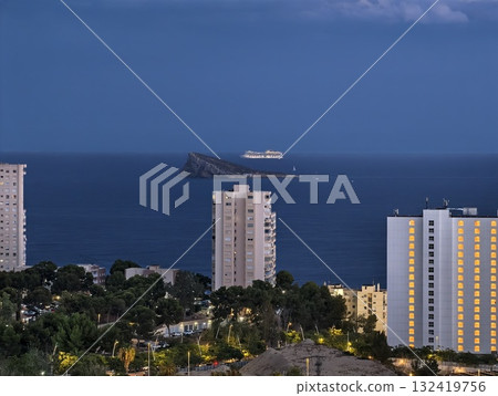 evening seaside skyline with lights, sunset coastal skyline featuring lit buildings over sea 132419756