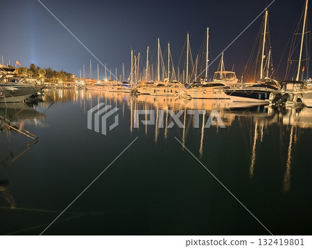 breathtaking harbor view with lights, vivid waterfront scene with shimmering reflections and masts 132419801
