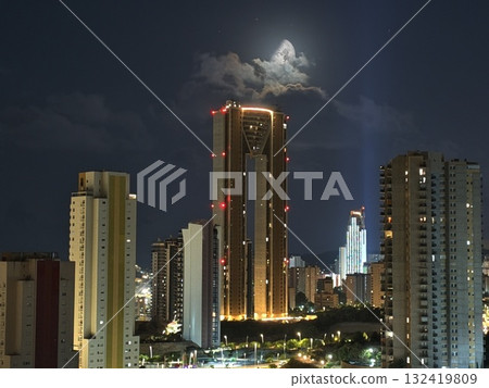 vibrant nighttime city panorama emphasizing upscale residences and bustling commercial activity 132419809