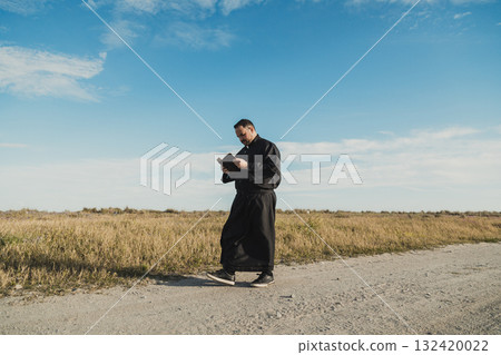 Blue Sky Over The Priest Reading The Bible  132420022