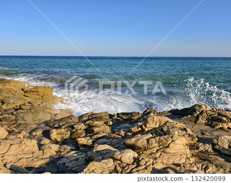 bright seaside scene, sunny rocky coast overview, sunlit rocky shoreline with calm waters bright seaside scene, sunny rocky coast overview, sunlit rocky shoreline with calm waters 132420099