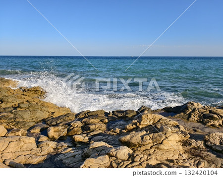 calm seaside environment with gentle waves, tranquil ocean view featuring soft surf and natural 132420104